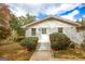 Front entrance featuring a white brick facade, steps, and mature landscaping at 105 Tranquility Dr, Villa Rica, GA 30180