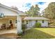 Home's front view features covered parking, inviting front door, and landscaped garden at 105 Tranquility Dr, Villa Rica, GA 30180