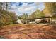 Leafy property showing a covered parking area with multiple vehicles and lush surroundings at 105 Tranquility Dr, Villa Rica, GA 30180