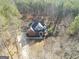 Aerial view of home featuring circular driveway and lush trees surrounding the property at 684 Brooks Woolsey Rd, Brooks, GA 30205