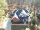 Aerial view of home featuring spacious driveway, beautifully landscaped yard, and tall trees at 684 Brooks Woolsey Rd, Brooks, GA 30205
