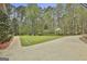 Spacious backyard with mature trees and lush green lawn. A serene and private outdoor space at 684 Brooks Woolsey Rd, Brooks, GA 30205