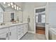 Bathroom featuring double sink vanity with white cabinets, gray walls, and view to bedroom at 684 Brooks Woolsey Rd, Brooks, GA 30205