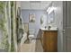Bathroom with neutral-tile flooring, green accented decor, and shower-tub combination at 684 Brooks Woolsey Rd, Brooks, GA 30205