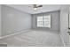 Bedroom with neutral gray walls, carpet, ceiling fan, and window at 684 Brooks Woolsey Rd, Brooks, GA 30205