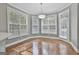 Open dining area with hardwood floors and a large window with blind shades allowing for great natural light at 684 Brooks Woolsey Rd, Brooks, GA 30205