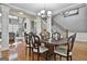 Elegant dining room featuring a dark wood table, hardwood floors, and staircase at 684 Brooks Woolsey Rd, Brooks, GA 30205