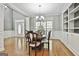 Well-lit dining room features hardwood floors, decorative chandelier, and a view of the front entrance at 684 Brooks Woolsey Rd, Brooks, GA 30205