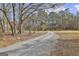 Gravel driveway winds through the trees to the home at 684 Brooks Woolsey Rd, Brooks, GA 30205