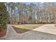 Expansive driveway and yard space perfect for parking and outdoor activities, surrounded by a tranquil wooded setting at 684 Brooks Woolsey Rd, Brooks, GA 30205