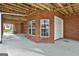 Underneath the rear deck of the house, showing brick walls, garage doors, and exposed beams at 684 Brooks Woolsey Rd, Brooks, GA 30205