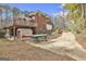 Exterior view of brick house with upper deck and garage, accompanied by kayaks in the driveway at 684 Brooks Woolsey Rd, Brooks, GA 30205