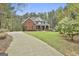 Beautiful brick home with lush landscaping, expansive lawn, and a long driveway, providing curb appeal and privacy at 684 Brooks Woolsey Rd, Brooks, GA 30205