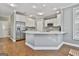 Bright kitchen featuring stainless steel appliances, white cabinets, hardwood floors, and modern countertops at 684 Brooks Woolsey Rd, Brooks, GA 30205
