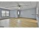 View of the spacious living room with wood floors, neutral paint, and a door leading to the exterior at 684 Brooks Woolsey Rd, Brooks, GA 30205