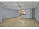 View of the spacious living room with wood floors, neutral paint, and a pass through to the kitchen at 684 Brooks Woolsey Rd, Brooks, GA 30205