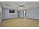 View of the spacious living room with wood floors, tv, and easy access to other rooms at 684 Brooks Woolsey Rd, Brooks, GA 30205