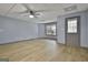 View of the spacious living room with wood floors, neutral paint, and access to the exterior at 684 Brooks Woolsey Rd, Brooks, GA 30205