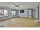 Spacious living room with hardwood floors, ceiling fan, and plenty of natural light from the large windows at 684 Brooks Woolsey Rd, Brooks, GA 30205