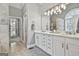 Large main bathroom featuring double sinks and a tiled shower with natural light coming from the arched window at 684 Brooks Woolsey Rd, Brooks, GA 30205