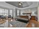 Spacious primary bedroom suite with sitting area, hardwood floors, large bed, and a decorative rug at 684 Brooks Woolsey Rd, Brooks, GA 30205