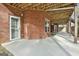 Spacious patio with brick wall, concrete floor, and view of backyard at 684 Brooks Woolsey Rd, Brooks, GA 30205