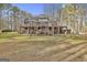 Home featuring a large back deck and spacious backyard filled with mature trees at 684 Brooks Woolsey Rd, Brooks, GA 30205