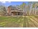 Two-story home featuring multiple decks and a brick exterior overlooking the yard at 684 Brooks Woolsey Rd, Brooks, GA 30205