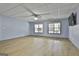 Spacious room with gray walls, wood floors, ceiling fan and windows at 684 Brooks Woolsey Rd, Brooks, GA 30205