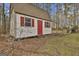 Charming shed with red door and shutters adding color to the landscape at 684 Brooks Woolsey Rd, Brooks, GA 30205