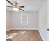 Bedroom featuring wood floor, ceiling fan, and a window with blinds at 4239 Newcomb Rd, Decatur, GA 30034