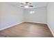 Bright bedroom featuring hardwood floors, neutral walls, and a ceiling fan with light at 4239 Newcomb Rd, Decatur, GA 30034