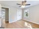 Bright bedroom featuring wood floors, ceiling fan, closet and large windows at 4239 Newcomb Rd, Decatur, GA 30034