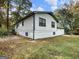 Side view of a home featuring white siding, black trim, and a well-maintained lawn at 4239 Newcomb Rd, Decatur, GA 30034
