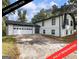 Fully renovated exterior of a two-story home featuring a spacious driveway at 4239 Newcomb Rd, Decatur, GA 30034