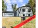 Renovated two-story home featuring an attached garage and classic architectural details with a well manicured lawn at 4239 Newcomb Rd, Decatur, GA 30034