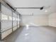 Garage featuring white door, grey floors, and an automatic opener at 4239 Newcomb Rd, Decatur, GA 30034