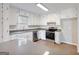 Bright kitchen featuring stainless steel appliances, white cabinetry, granite countertops, and ample natural light at 4239 Newcomb Rd, Decatur, GA 30034