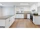 Updated kitchen features stainless steel appliances, gray countertops, an island and white cabinets at 4239 Newcomb Rd, Decatur, GA 30034