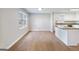 Open concept living space featuring hardwood floors, large windows, and a kitchen with an island at 4239 Newcomb Rd, Decatur, GA 30034