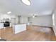 Spacious living room boasts natural light, an adjacent kitchen with an island, and a modern staircase at 4239 Newcomb Rd, Decatur, GA 30034