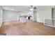 Open floor plan showcases a spacious living area flowing into a kitchen with white cabinetry and hardwood floors at 4239 Newcomb Rd, Decatur, GA 30034