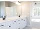 Bathroom with a double sink vanity, black hardware, and view into the adjoining bedroom at 152 Wet Wood Dr # 10, Fairburn, GA 30213