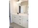 Modern bathroom vanity with double sinks, white cabinets, and sleek black hardware with grey tile flooring at 152 Wet Wood Dr # 10, Fairburn, GA 30213