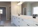 Bright bathroom vanity with double sinks, white cabinets, black hardware, and an attached glass shower at 152 Wet Wood Dr # 10, Fairburn, GA 30213