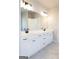 Modern bathroom features a dual sink vanity with white cabinets and black hardware at 152 Wet Wood Dr # 10, Fairburn, GA 30213
