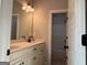Modern bathroom featuring a double sink vanity with black fixtures and a view of the bathtub at 152 Wet Wood Dr # 10, Fairburn, GA 30213