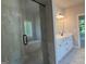 Beautiful bathroom with glass shower, soaking tub, and double vanity with white cabinets and black hardware at 152 Wet Wood Dr # 10, Fairburn, GA 30213