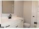 Stylish bathroom featuring a white vanity with black hardware, a framed mirror, and modern fixtures at 152 Wet Wood Dr # 10, Fairburn, GA 30213