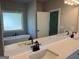 Bright bathroom featuring a soaking tub, tiled floors and double sink vanity with black fixtures at 152 Wet Wood Dr # 10, Fairburn, GA 30213